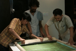 Phuong, Hoang and Nam creating a silk screened image